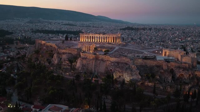 Evening drone shot of Acropolis in Athens, Greece, Ancient Greek architecture, Parthenon drone shot, ancient history landmark with night illumination
