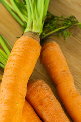 orange carrot close-up lies on table on wooden background