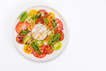 Fresh burrata served on slices of colorful tomatoes