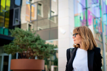 Confident business woman walking in the city