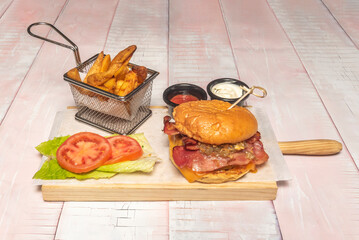 A tall and mouthwatering burger with a brioche bun, triple beef, triple cheese, and abundant bacon, a challenge to eat.