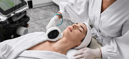 Removal of brown spots and freckles on a woman's body at cosmetology using machine with intense pulsed light IPL technology