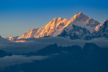 Beautiful last light from sunset on Mount Kanchenjugha, Himalayan mountain range, Sikkim, India. color tint on the mountains at dusk