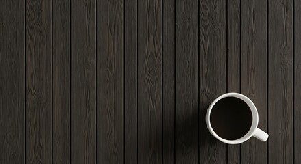 Overhead view of a white coffee cup on a dark wooden table