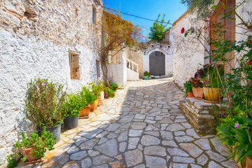 Narrow street in the old village of Afionas, surrounded by white architecture, on the Greek island of Corfu, background or wallpaper for a project