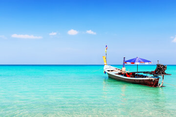 Traditional local long tail boat on a beautiful tropical beach in sunny day, in Phuket, Thailand