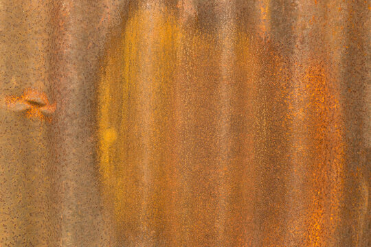 The image is of a rusty metal surface with a brown and yellow color