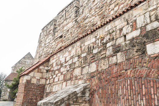 A brick wall with a red roof