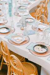 Brightly decorated dining table ready for a festive gathering with cheerful tableware and wooden chairs