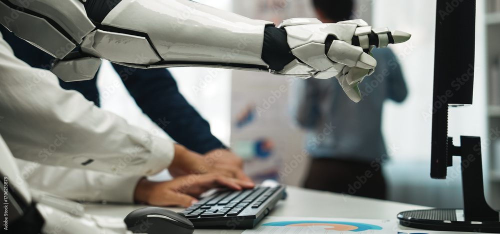 Poster a robotic arm engages with a computer in a modern office, highlighting the blend of human ingenuity 