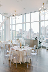 Elegant dining space with city views and festive decorations for a special event in a bright venue