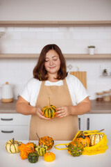 woman preparing for harvest festival, Pumpkins in Eco-Friendly Bag on Table in kitchen