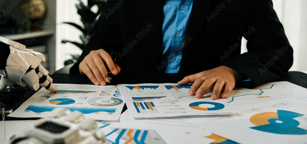 Poster a business professional examines various graphs and data charts while utilizing futuristic technolog