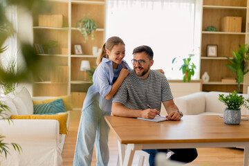 Joyful moments of creativity shared between father and daughter at home
