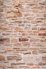Rustic Natural Stone Masonry Wall Texture Background in Warm Colors