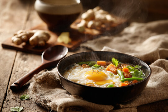 Hot rice porridge with snap peas, carrots, and soy sauce drizzle. Soft light highlights texture. Ideal for Asian cuisine ads