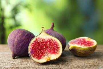 Fresh ripe figs on wooden table outdoors, closeup