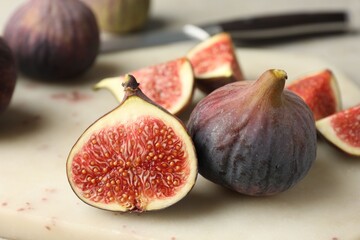 Whole and cut figs on light table, closeup