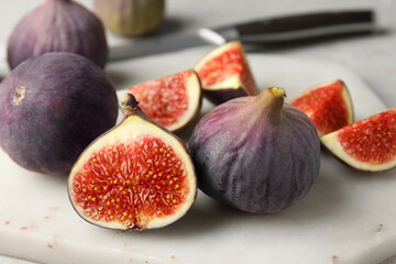 Whole and cut figs on light table, closeup