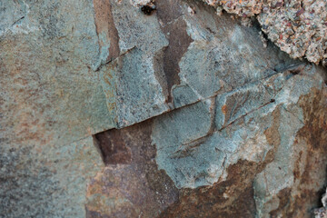 texture di superficie rocciosa ruvida e naturale dalle sfumature di azzurro e grigio, con venature...