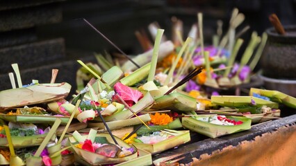 Balinese Flowers and incense sticks for warship in a temple