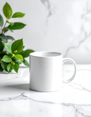 Blank white mug on a marble surface with green foliage