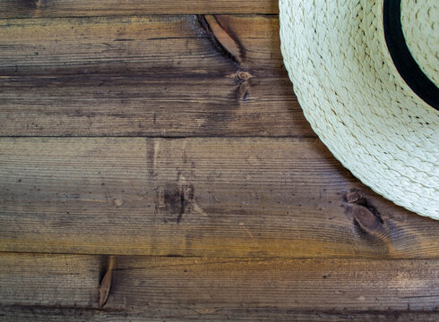 Summer vacation, flatlay. Hat on a dark wooden background.