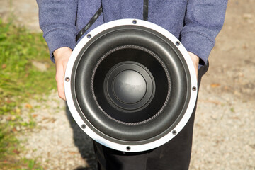 Obraz premium Car subwoofer. Car audio system in a man's hands.
