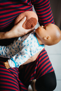 Explaining breastfeeding with a doll and fake boob