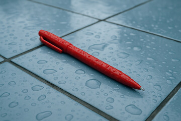 red pen on a light blue background.Red pen on a light blue surface.