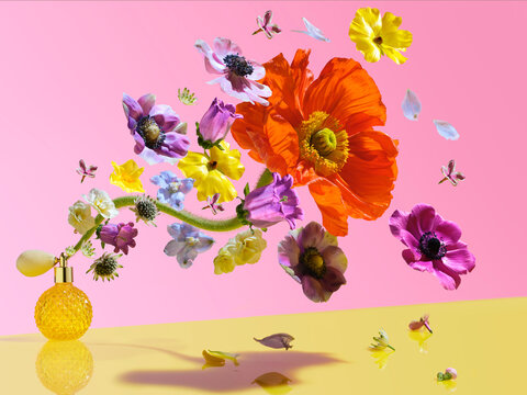 perfume bottle spraying flowers and petals