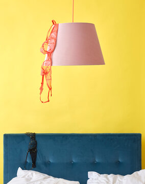 Bedroom with bra hanging off lampshade