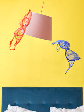 Bedroom with bra hanging off lampshade