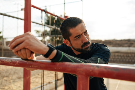 Athlete resting after workout at outdoor gym - Powered by Adobe
