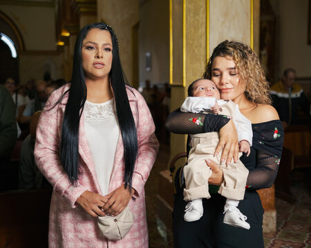 Mother and godmother at a baby's baptism