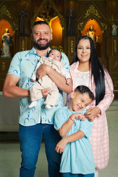 Happy family at the baptism of their baby
