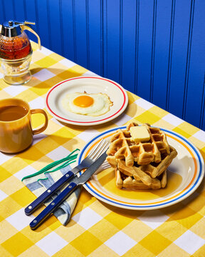 Classic Diner Breakfast with Waffles & Egg on Yellow Checkered Cloth