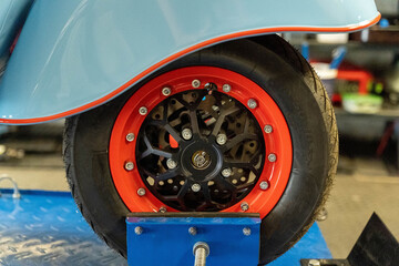 Mechanic balancing scooter wheel on a balancing machine in workshop © Андрей Знаменский