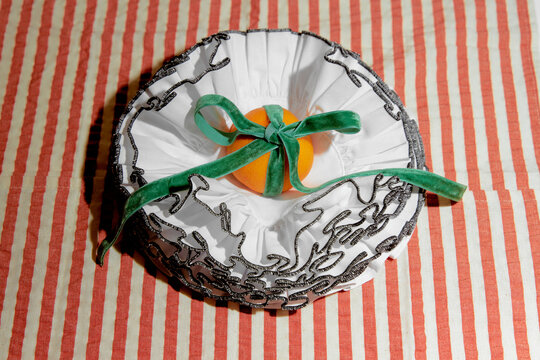 Orange Wrapped in White Fabric