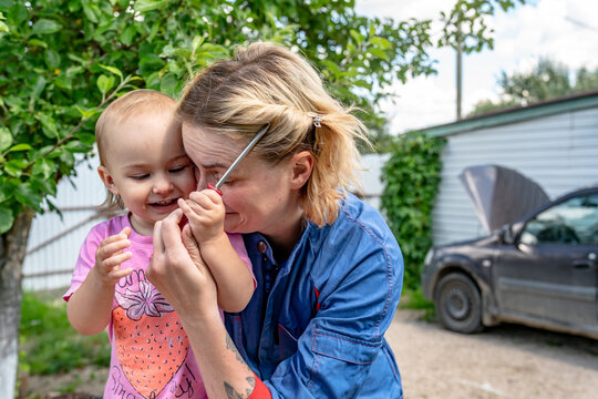 Female Mechanic Working While Family  Interest