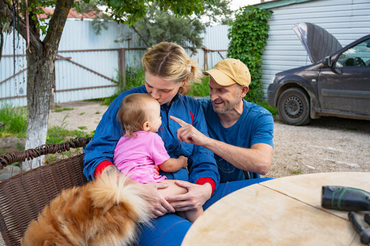 Female Mechanic Working While Family  Interest