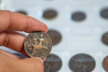 Numismatics concept. Hand of numismatic collector holding a coin