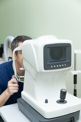 A man has his eyesight checked by an ophthalmologist, a person undergoes ophthalmometry