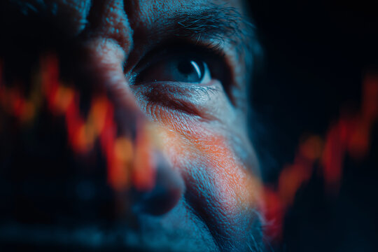 Close up of man eye with stock market graph overlay, symbolizing financial focus and analysis. image conveys intensity and concentration in world of finance