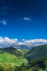 Naklejka premium A peaceful autumn scene in Moeciu Village, near Brasov, Romania. The rural landscape of the Carpathian Mountains is painted in warm fall hues, with rolling hills, traditional wooden houses