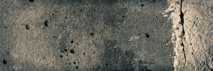 Texture of old cracked concrete wall. Rough gray concrete surface. Wide panoramic background for design.
