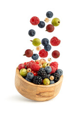 Gooseberry berries in a wooden plate isolated on a white background
