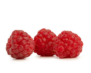 Raspberry berries in a wooden plate isolated on a white background