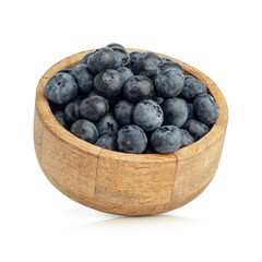 Blueberry berries in a wooden plate isolated on a white background
