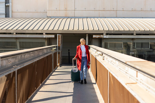 a woman with her suitcase at an airport